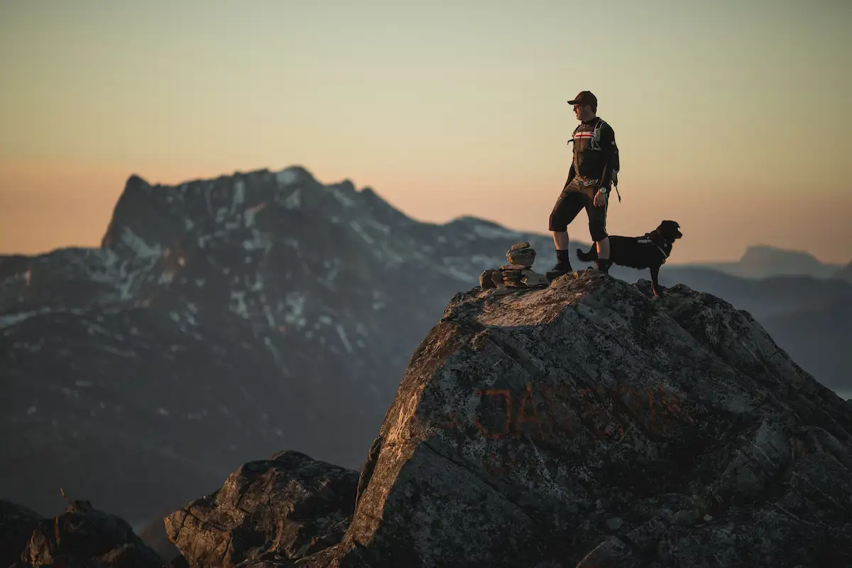 A Hiker On The Peak Of Ukkusissaq Store Malene Outside Nuuk In Greenland With The Mountain Sermitsiaq In The Background (1)