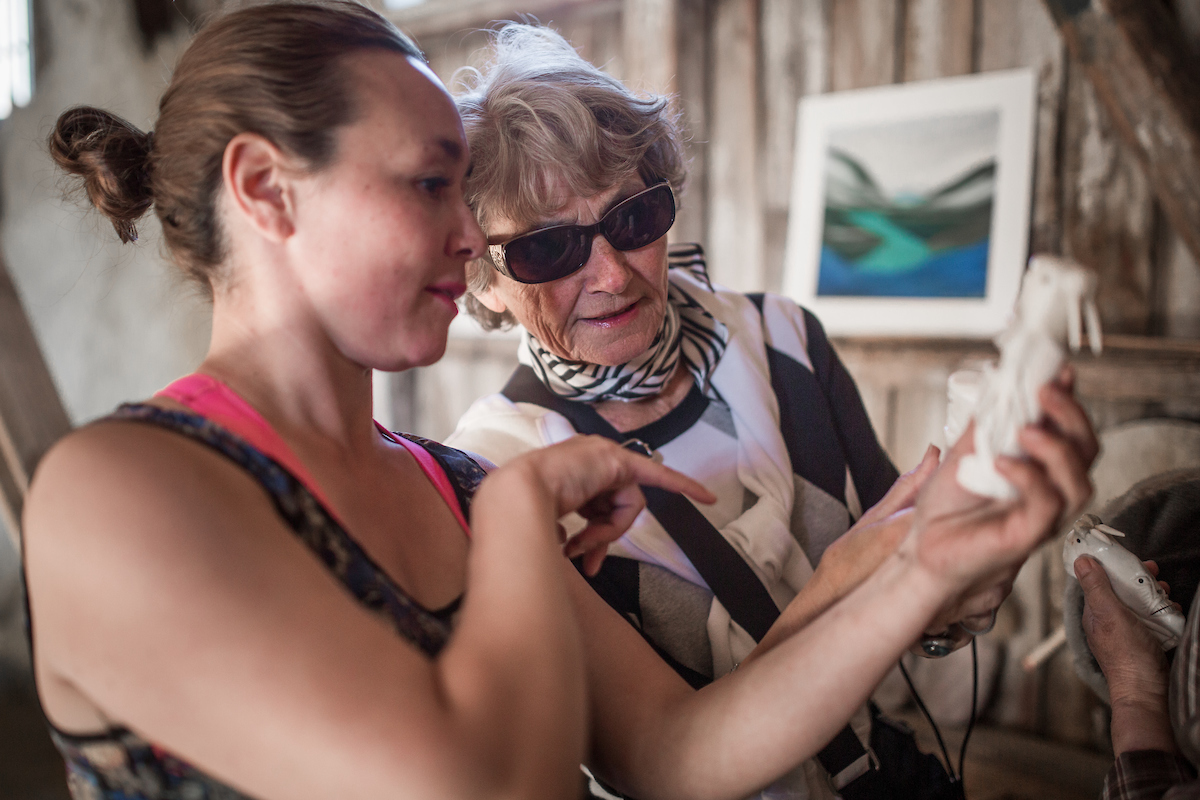 Kattie From Hotel Narsaq Telling A Guest About A Tupilak Bone Carving From Narsaq In South Greenland