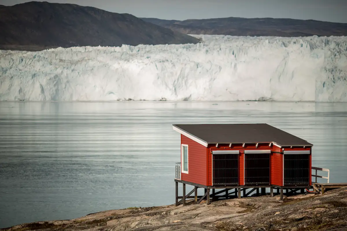A Comfort Hut At Eqi Glacier Lodge With The Glacier In The Background In North Greenland