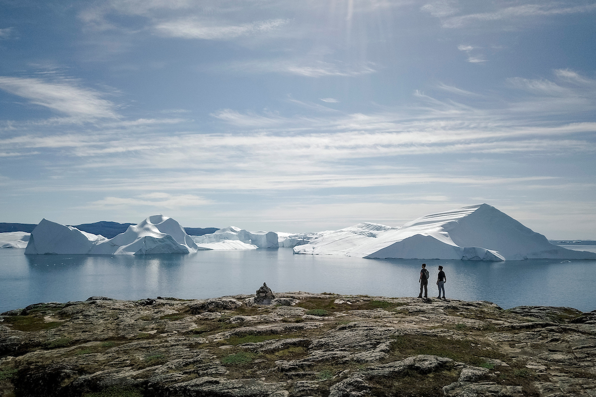 Two Hikers Look At Ilulissat Icefjord. Aningaaq Rosing Carlsen Visit Greenland