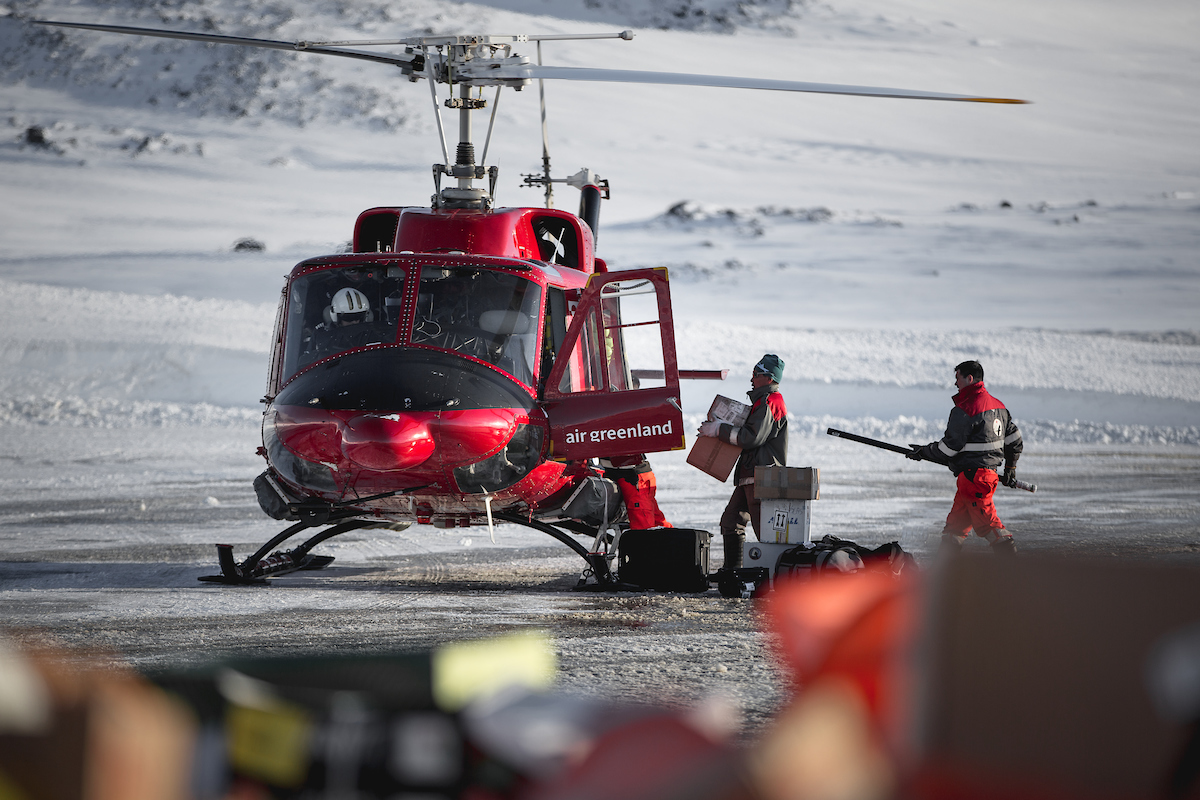 Airport Personnel Loading An Air Greenland Bell 212 Passenger Helicopter In Kulusuk Airport, East Greenland